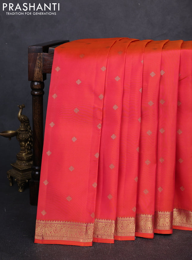 Kanchipuram silk saree dual shade of pinkish orange and teal green with allover zari woven buttas and zari woven border