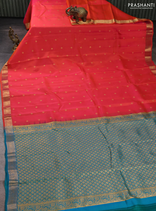 Kanchipuram silk saree dual shade of pinkish orange and teal green with allover zari woven buttas and zari woven border