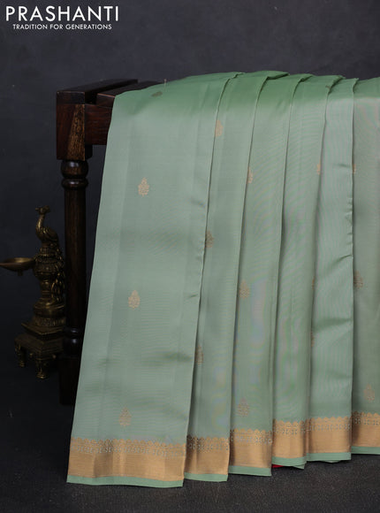 Kanchipuram silk saree teal shade and pink with allover zari woven buttas and zari woven border
