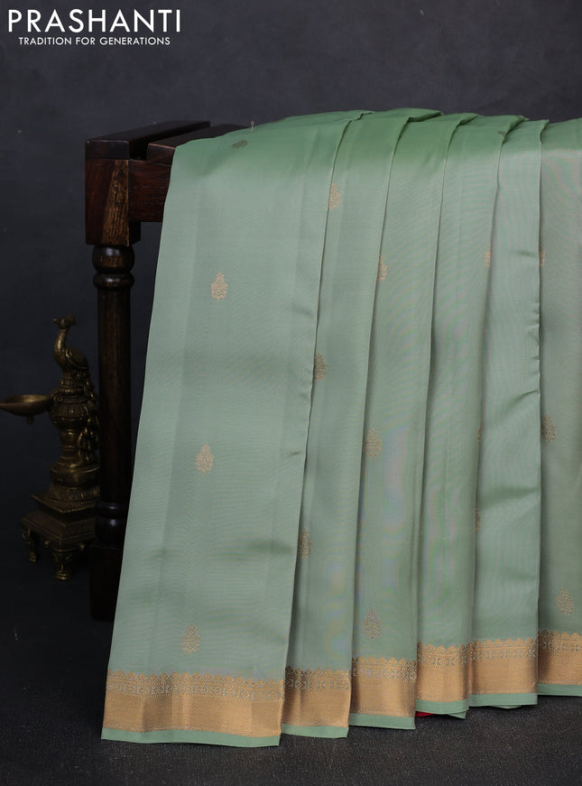 Kanchipuram silk saree teal shade and pink with allover zari woven buttas and zari woven border