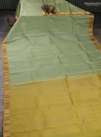 Kanchipuram silk saree pastel green and mustard green with allover zari woven buttas and zari woven border