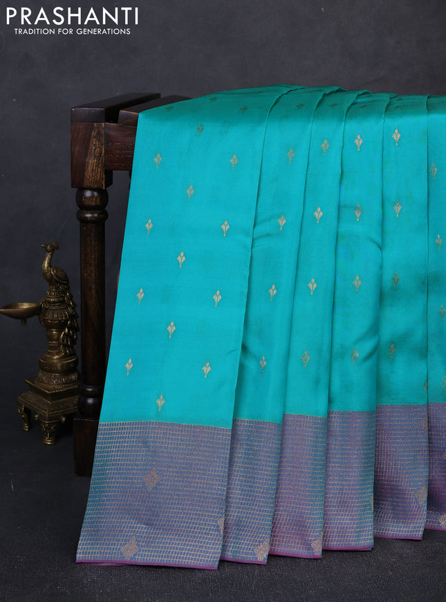 Kanchipuram silk saree teal green and dual shade of purple with allover zari woven buttas and long zari woven border