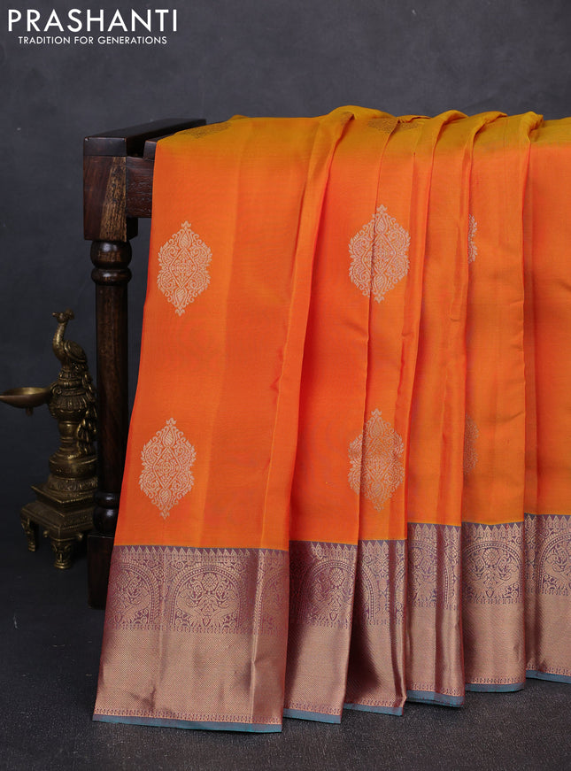 Kanchipuram silk saree sunset orange and teal green with zari woven buttas and rich zari woven border