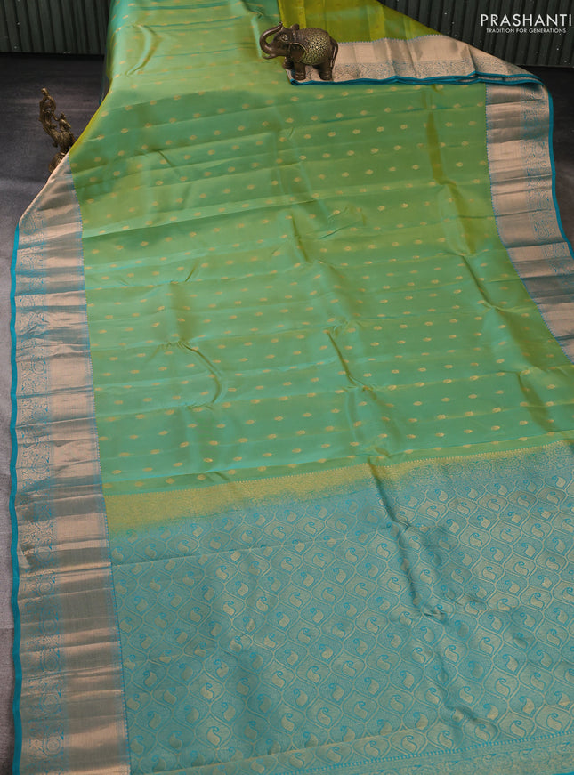 Kanchipuram silk saree dual shade of teal green and teal blue with allover zari woven buttas and long zari woven border