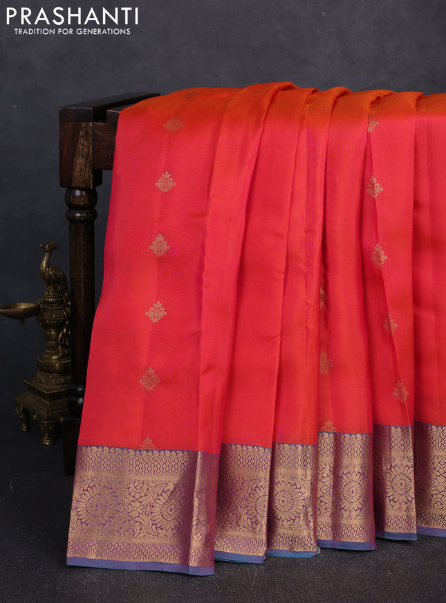 Kanchipuram silk saree dual shade of pinkish orange and dual shade of teal green with allover zari woven buttas and long zari woven border