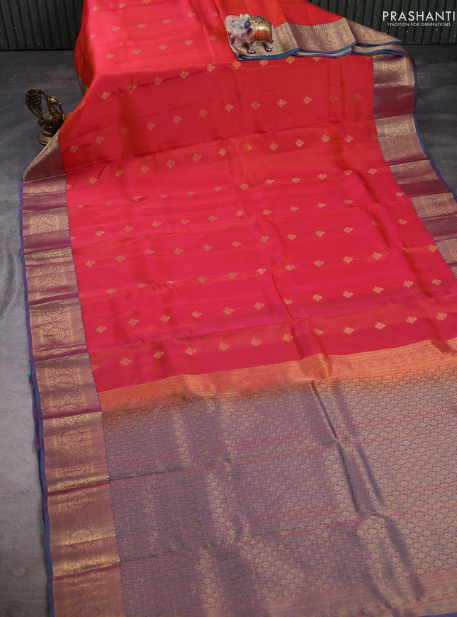 Kanchipuram silk saree dual shade of pinkish orange and dual shade of teal green with allover zari woven buttas and long zari woven border