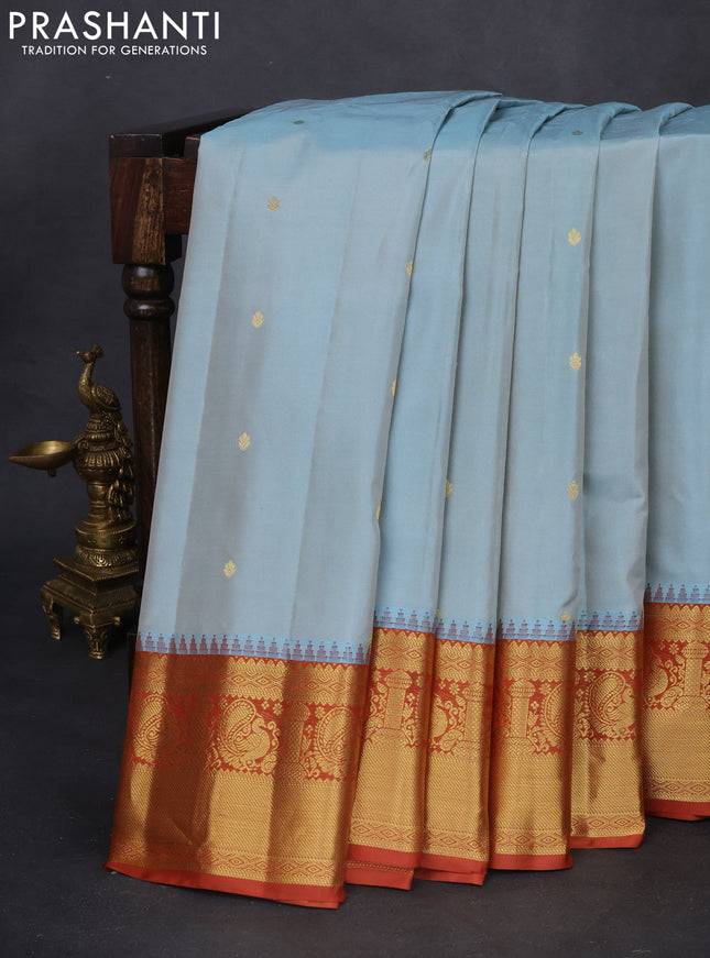 Pure gadwal silk saree pastel blue and rust shade with zari woven buttas and temple design zari woven border