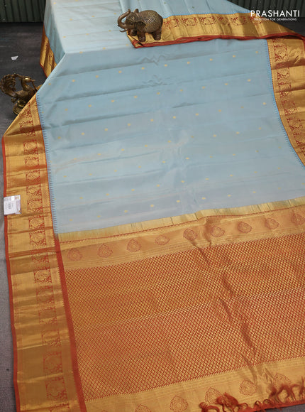 Pure gadwal silk saree pastel blue and rust shade with zari woven buttas and temple design zari woven border