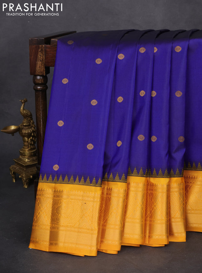 Pure gadwal silk saree dark blue and mustard yellow with zari woven buttas and temple design zari woven border