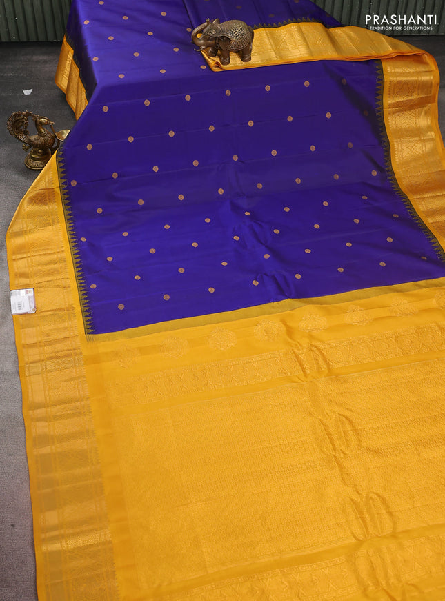 Pure gadwal silk saree dark blue and mustard yellow with zari woven buttas and temple design zari woven border