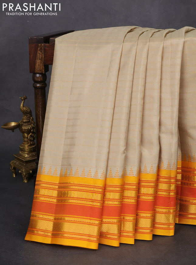 Pure gadwal silk saree beige and dark mustard with allover checked pattern and temple design zari woven border