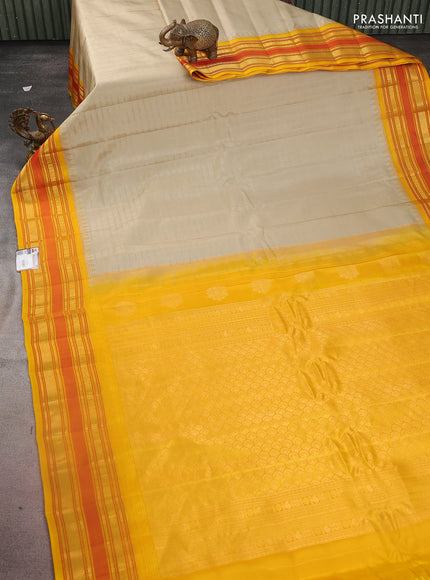 Pure gadwal silk saree beige and dark mustard with allover checked pattern and temple design zari woven border