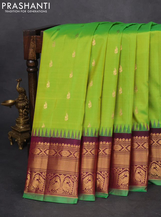 Pure gadwal silk saree light green and dark magenta pink with zari woven buttas and temple design zari woven border