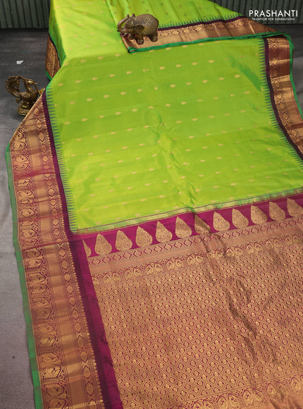 Pure gadwal silk saree light green and dark magenta pink with zari woven buttas and temple design zari woven border
