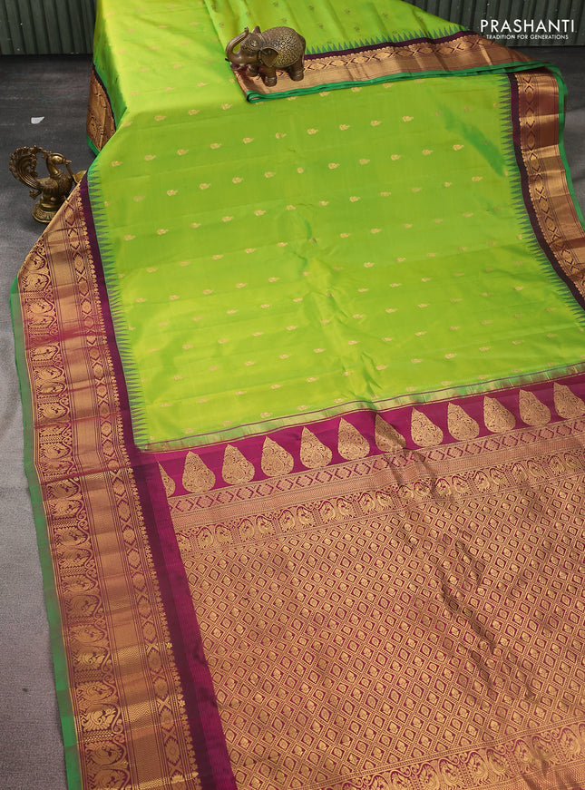 Pure gadwal silk saree light green and dark magenta pink with zari woven buttas and temple design zari woven border