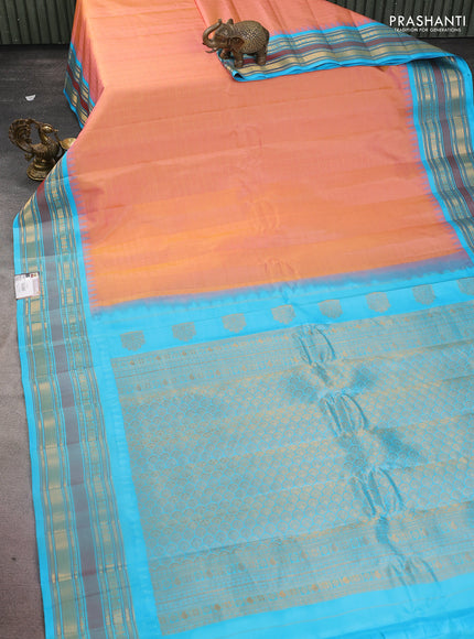 Pure gadwal silk saree dual shade of peach and teal blue with allover zari checked pattern and temple design zari woven border