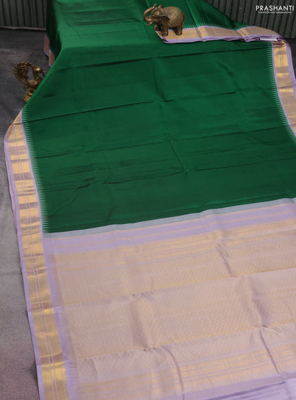 Pure kanchipuram silk saree green and pastel lavender with plain body and temple design zari woven border