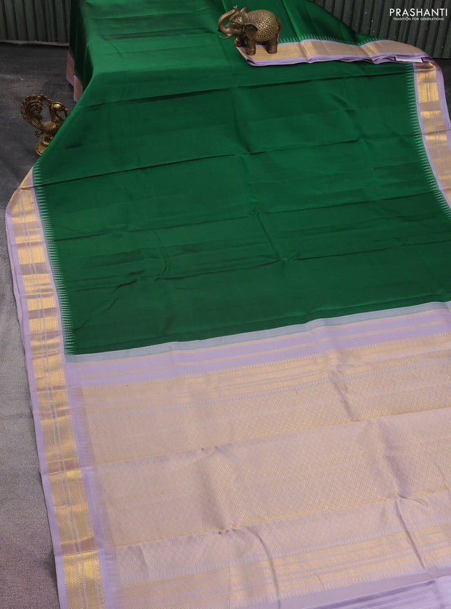 Pure kanchipuram silk saree green and pastel lavender with plain body and temple design zari woven border