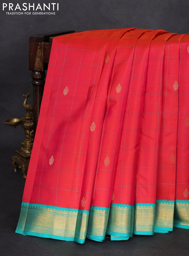 Pure kanchipuram silk saree dual shade of pinkish orange and teal blue with allover checks & zari buttas and zari woven korvai border