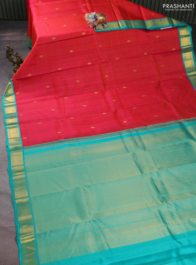 Pure kanchipuram silk saree dual shade of pinkish orange and teal blue with allover checks & zari buttas and zari woven korvai border