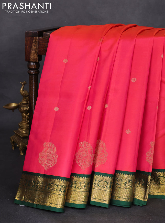 Pure kanchipuram silk saree dual shade of pinkish orange and dark green with zari woven buttas and zari woven korvai border