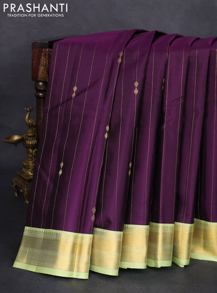Pure kanchipuram silk saree deep purple and pista green with allover zari weaves and zari woven korvai border