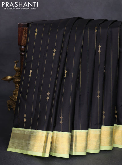 Pure kanchipuram silk saree black and pista green with allover zari weaves and zari woven korvai border
