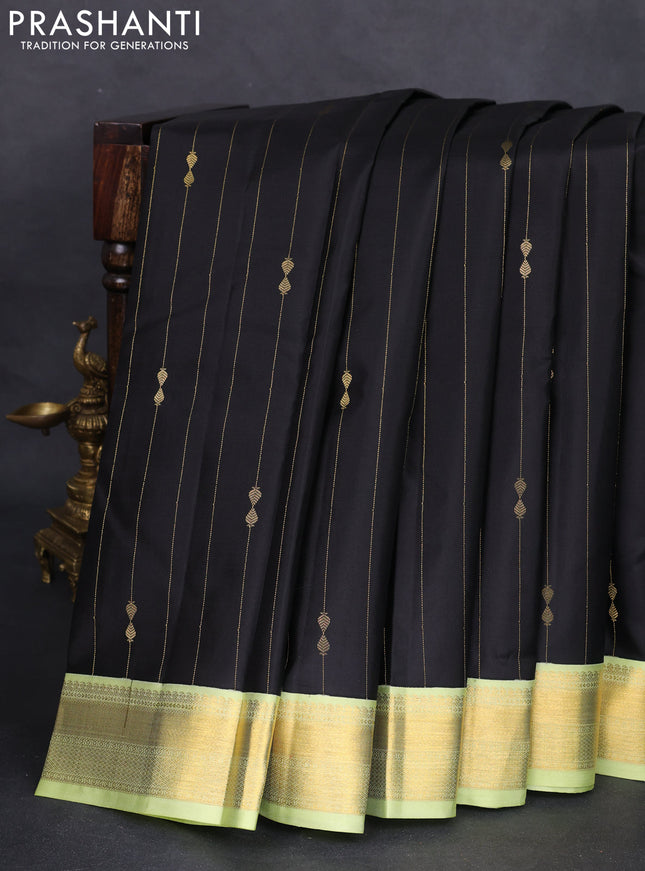 Pure kanchipuram silk saree black and pista green with allover zari weaves and zari woven korvai border