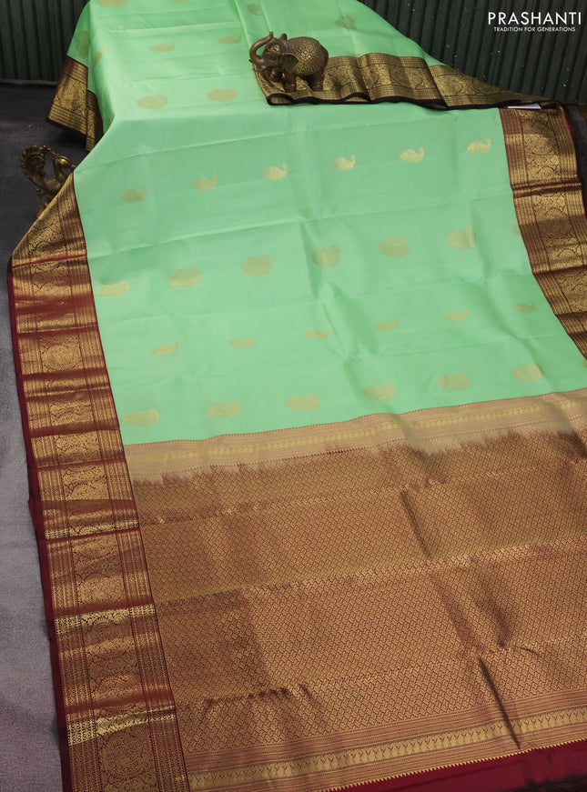 Pure kanchipuram silk saree pista green and deep maroon with zari woven buttas and zari woven korvai border