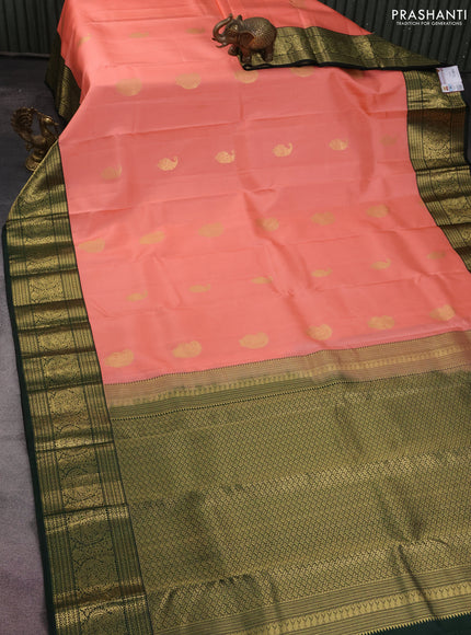 Pure kanchipuram silk saree peach shade and dark bottle green with zari woven buttas and zari woven korvai border