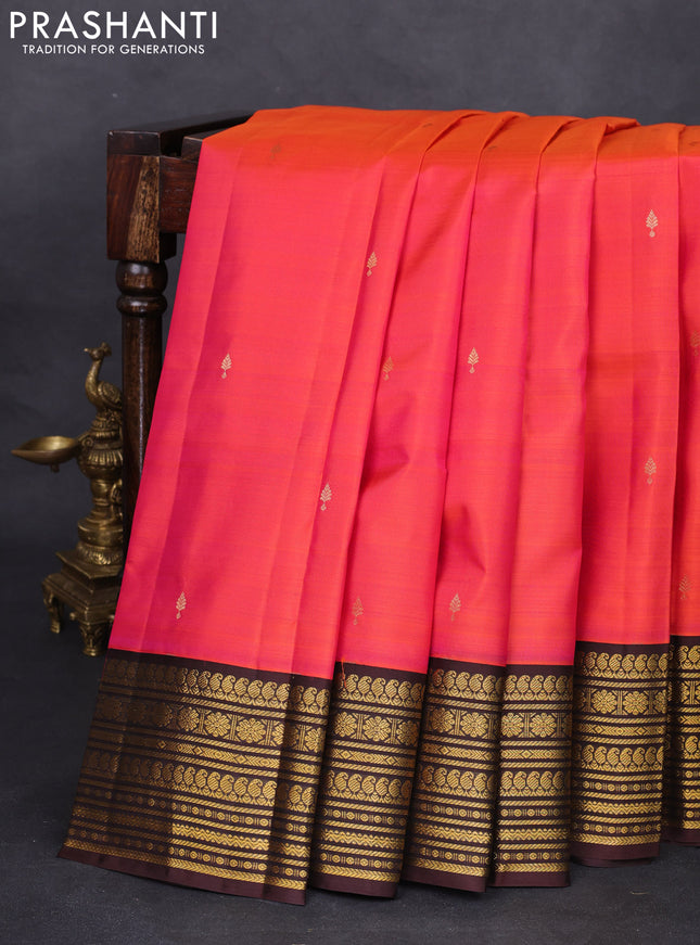 Pure kanchipuram silk saree dual shade  of pinkish orange and brown with zari woven buttas and zari woven korvai border