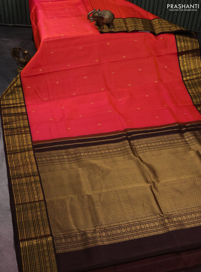 Pure kanchipuram silk saree dual shade  of pinkish orange and brown with zari woven buttas and zari woven korvai border