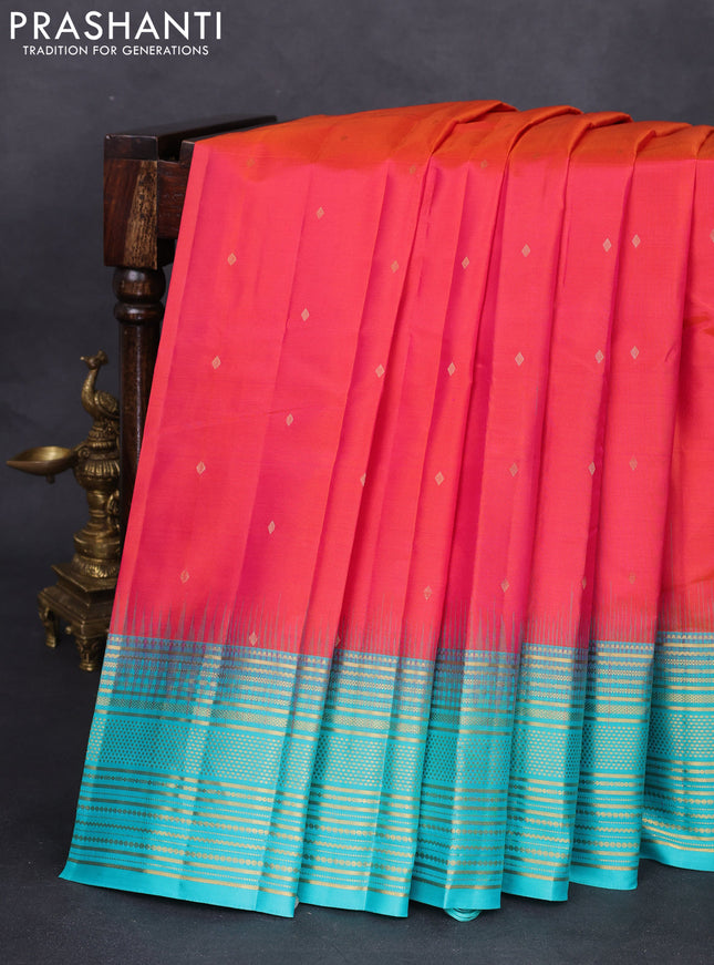 Pure kanchipuram silk saree dual shade of pinkish orange and teal blue with zari woven buttas and rich zari border