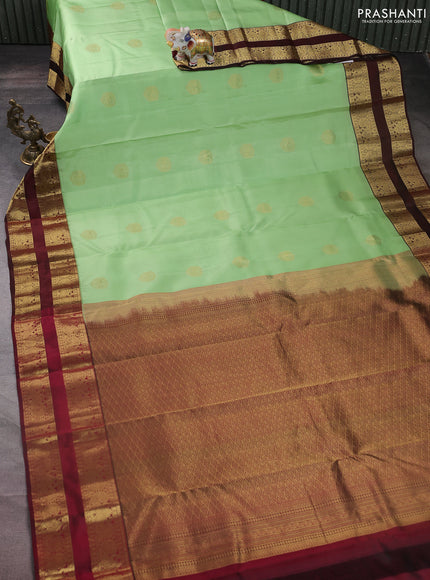 Pure kanchipuram silk saree pista green and deep maroon with zari woven buttas and rettapet zari woven korvai border
