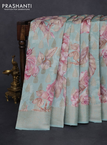 Chiniya silk saree teal blue shade with allover zari buttas & floral digital prints and woven border