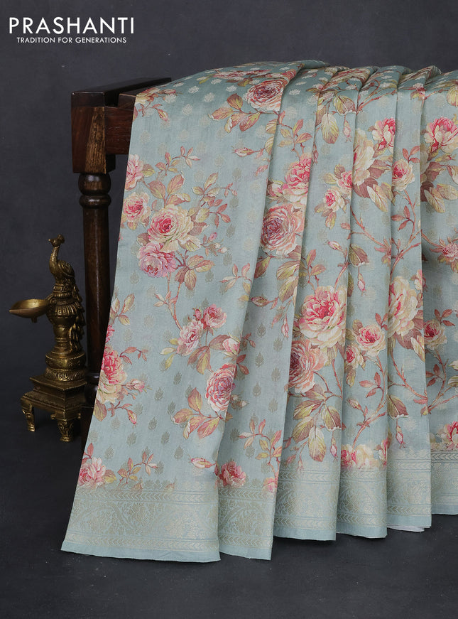 Chiniya silk saree pastel blue shade with allover zari buttas & floral digital prints and woven border