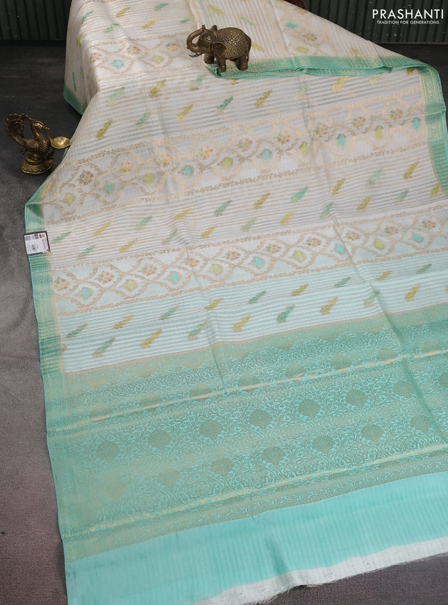 Chiniya silk saree off white and teal blue with allover zari weaves & digital prints and zari woven border