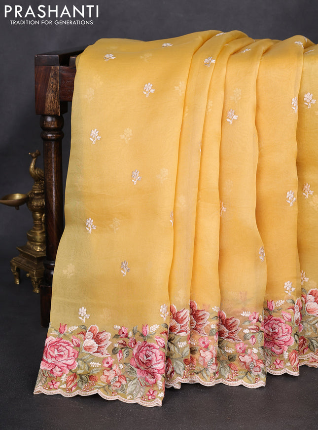 Pure organza silk saree yellow with embroidery work buttas and floral design embroidery border