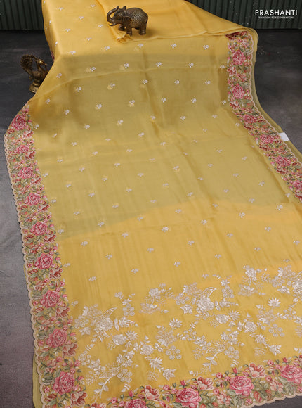 Pure organza silk saree yellow with embroidery work buttas and floral design embroidery border