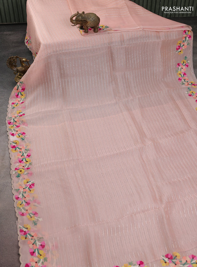 Pure organza silk saree pastel peach with allover silver & gold zari weaves and floral design embroidery border