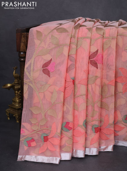 Pure organza silk saree peach shade with allover floral embroidery and silver zari woven border