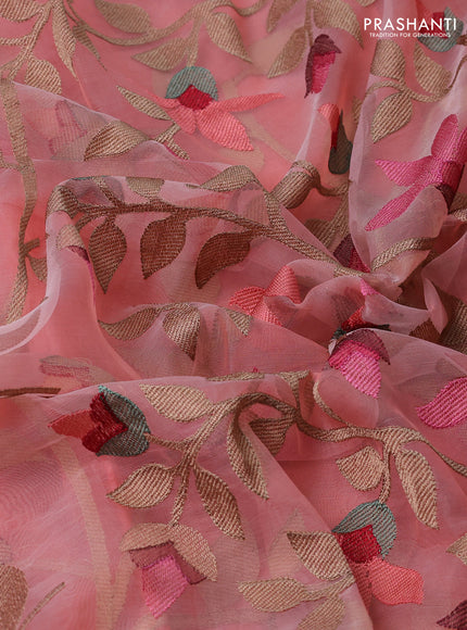 Pure organza silk saree peach shade with allover floral embroidery and silver zari woven border