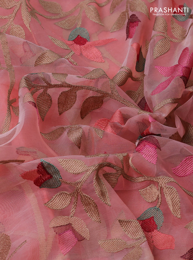 Pure organza silk saree peach shade with allover floral embroidery and silver zari woven border