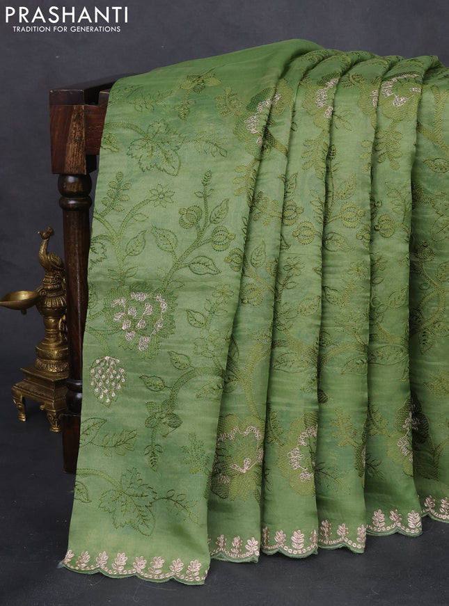 Pure organza silk saree pastel green with allover floral embroidery and zari woven border