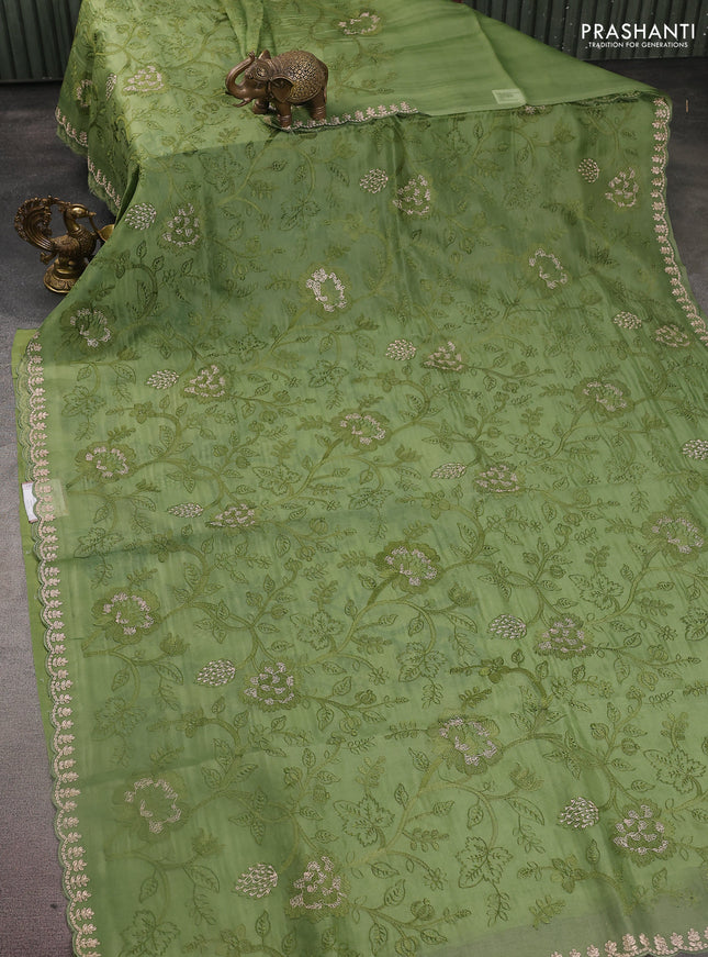 Pure organza silk saree pastel green with allover floral embroidery and zari woven border
