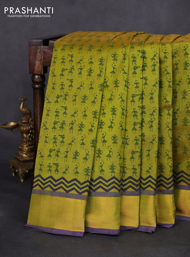 Silk cotton block printed saree dual shade of light green and violet with allover warli prints and zari woven border