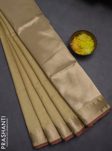 Semi dupion saree cream and maroon with plain body and temple design zari woven border