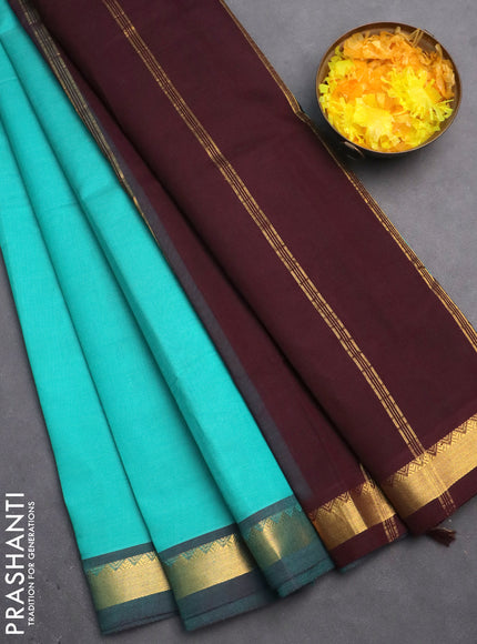 Silk cotton saree teal blue and wine shade with plain body and zari woven border