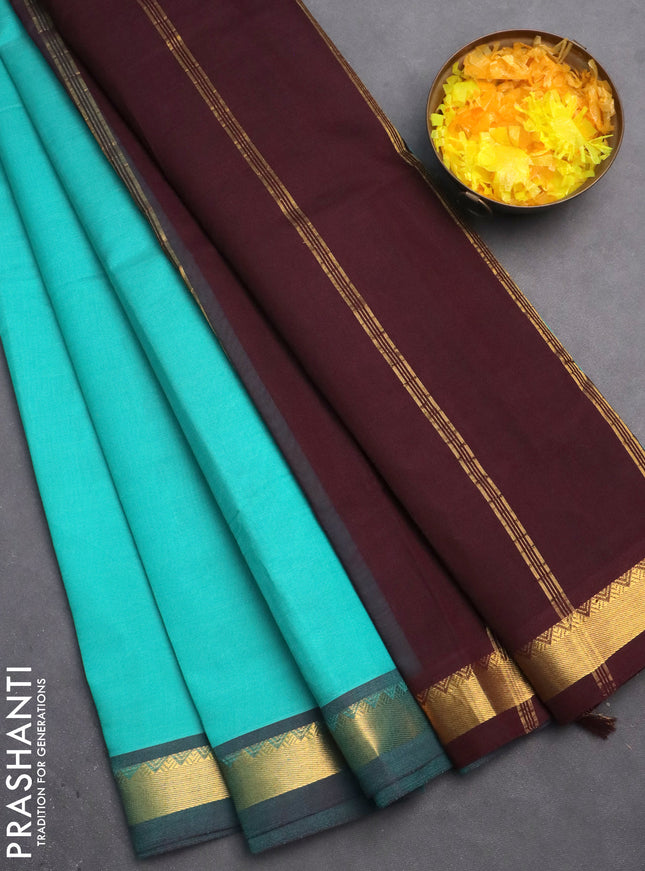 Silk cotton saree teal blue and wine shade with plain body and zari woven border