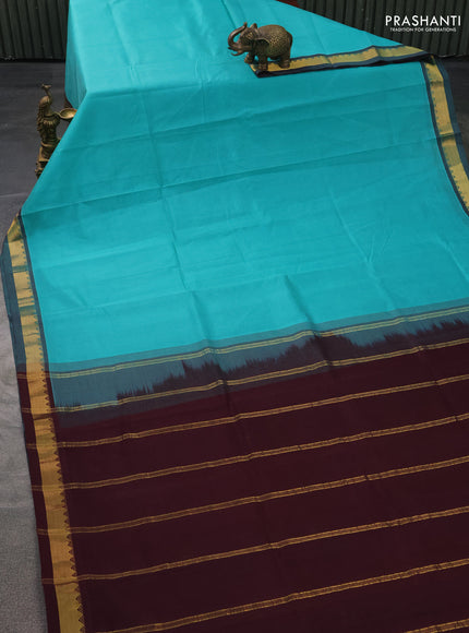 Silk cotton saree teal blue and wine shade with plain body and zari woven border